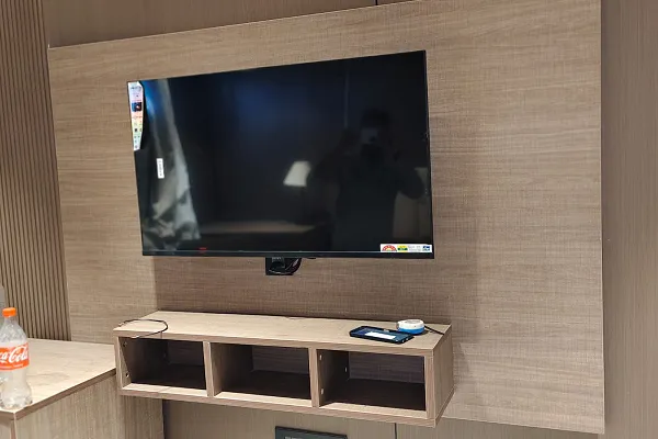 Hotel room TV unit with wooden wall panelling
